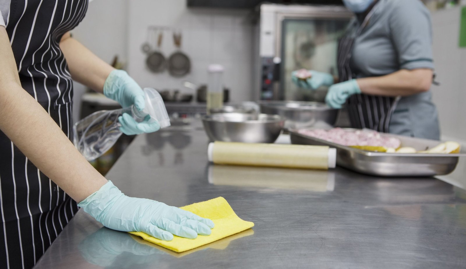 woman-disinfecting-and-cleaning-kitchen-table-