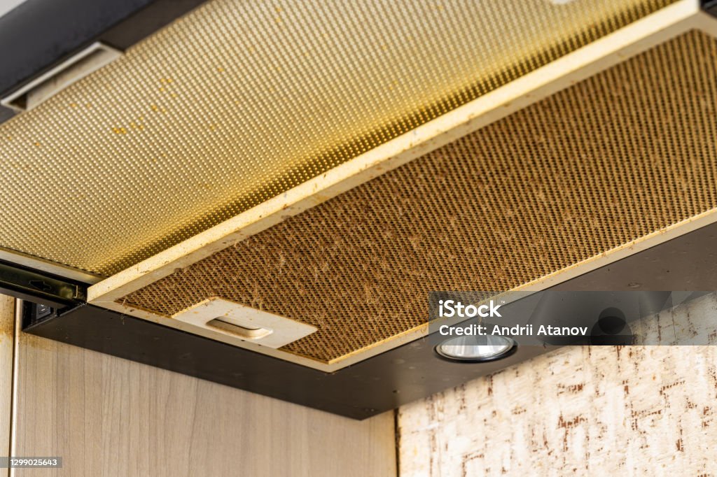 cleaning and washing dirty cooker hood filter. fat and dust at filter. domestic kitchen.